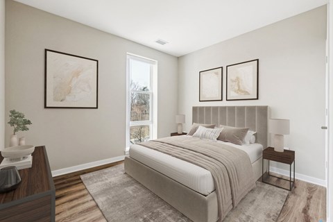 A bedroom with a large bed and two framed pictures on the wall.