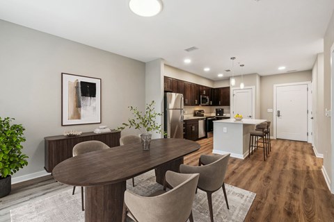 A dining room with a table and chairs.