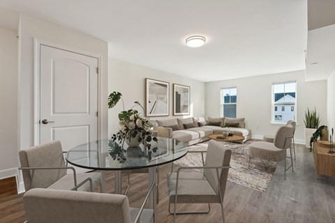 A modern dining room with a glass table and chairs.