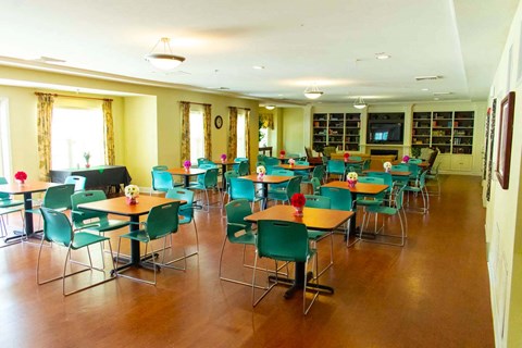 a dining room with tables and chairs and a tv