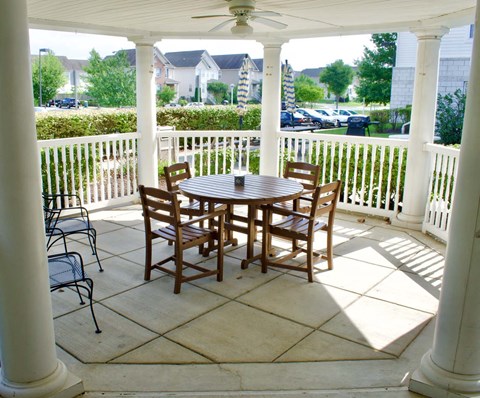 A gorgeous gazebo with a table and chairs.