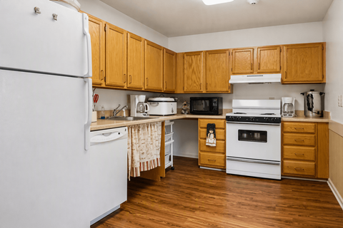 A kitchen with wooden cabinets and white appliances.
