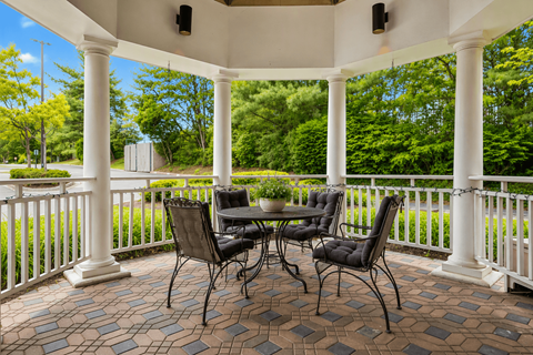 A patio with a table and chairs.