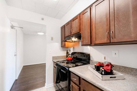 Modern kitchen with sleek, black appliances and ample cabinet space inside a market-rate 2-bedroom unit at Edgewood Commons 601, located near local dining and entertainment in Northeast DC.