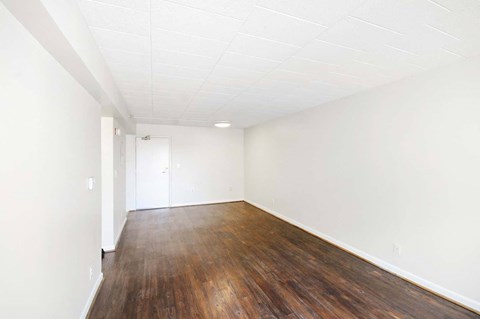 Open concept living and dining inside a market-rate apartment at Edgewood Commons 601 featuring hardwood floors, bright natural light, and energy-efficient appliances in Washington, DC.