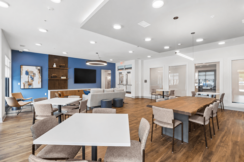 A modern dining area with wooden tables and chairs.