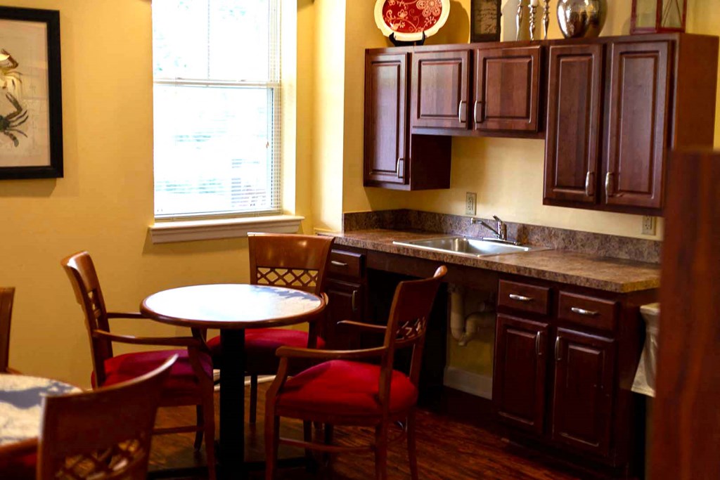 a kitchen with a table and chairs and a sink