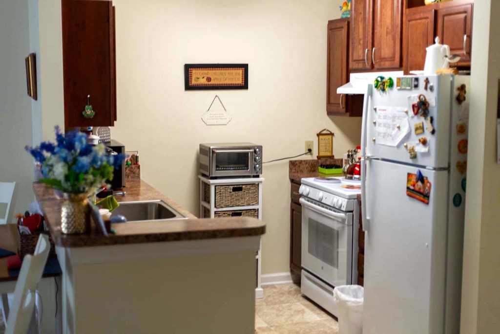a kitchen with a stove refrigerator and a sink