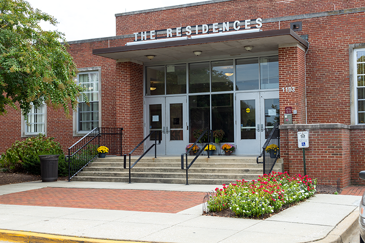 a brick building with a sign that reads the residences
