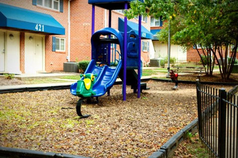 a playground with a blue swing set