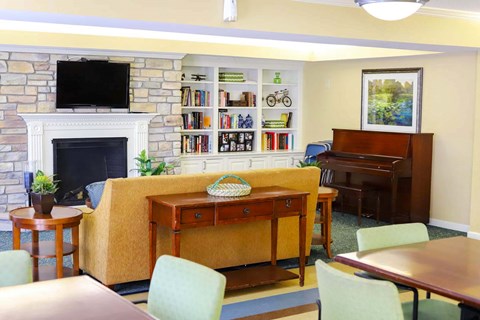 a living room with a couch and a piano