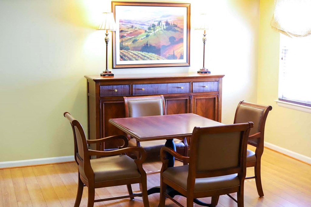 a dining room with a table and chairs