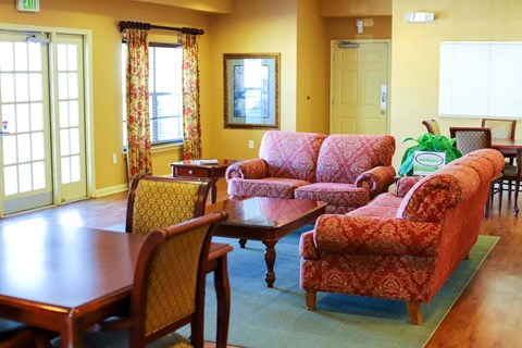 a living room with couches and chairs and a table