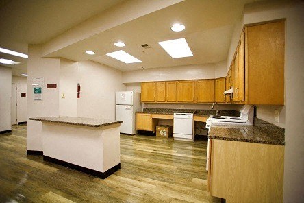 a large kitchen with wooden cabinets and white appliances