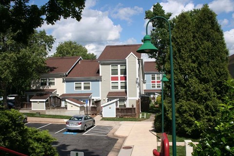 a row of houses with a car parked in a parking lot