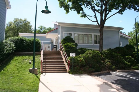 the front of a blue house with stairs