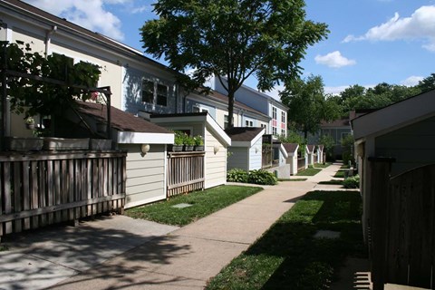 a row of houses with a sidewalk in front of them