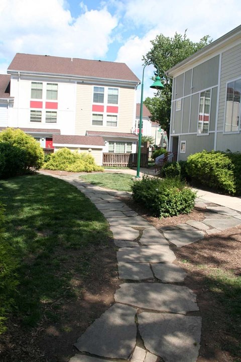 a stone walkway in front of a house