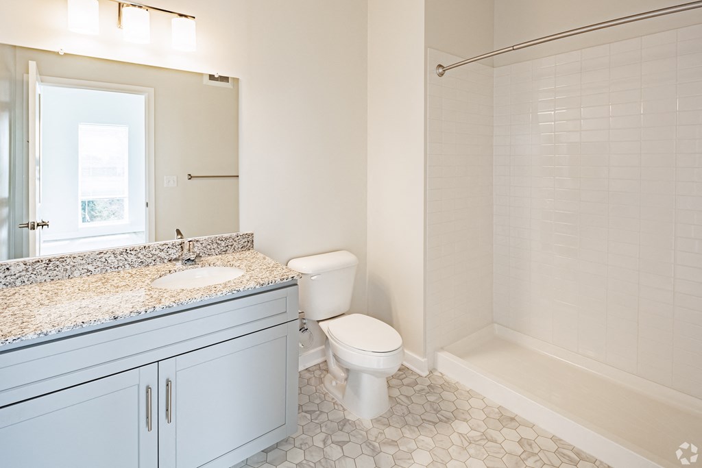 an image of a bathroom with a sink toilet and shower