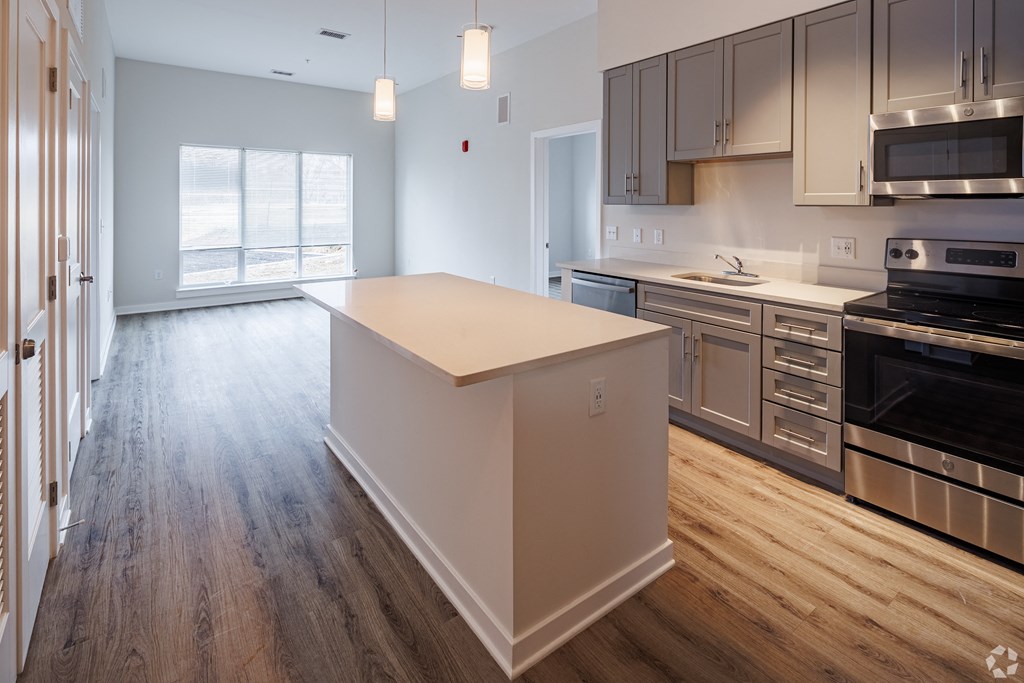 an empty kitchen with an island in the middle of it