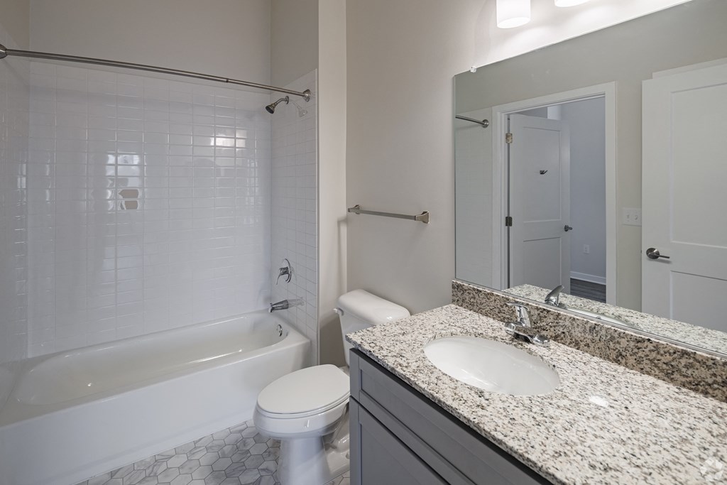 a bathroom with a sink and a toilet and a tub
