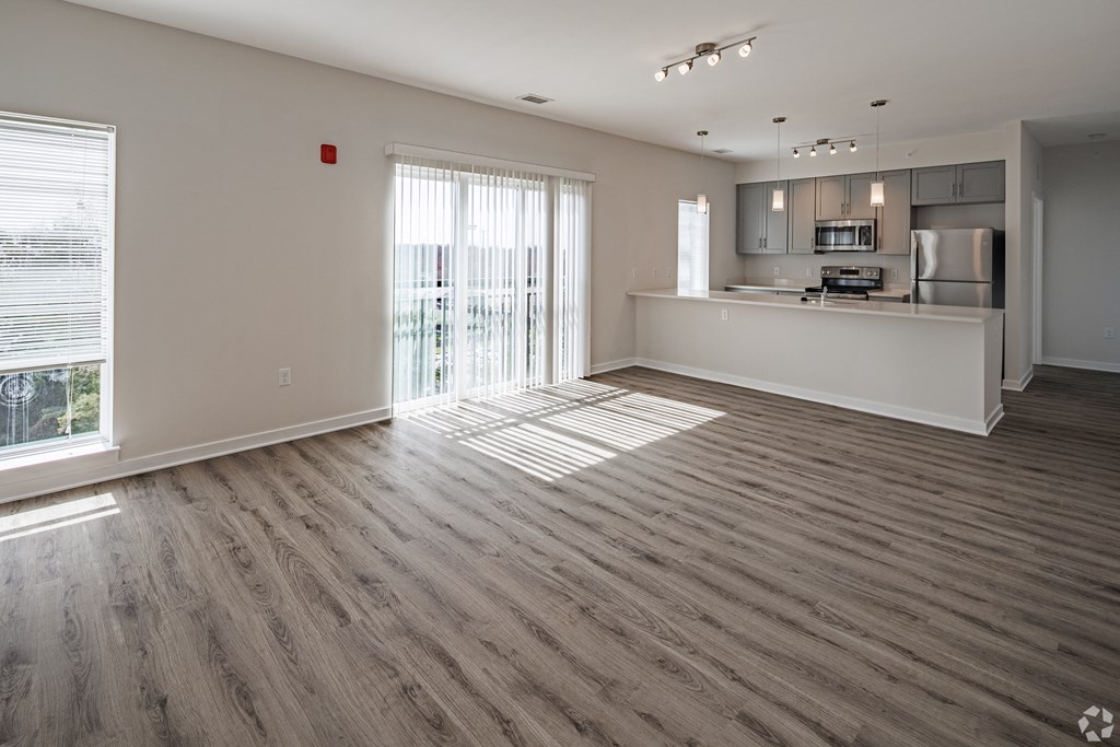 an empty living room and kitchen in a new home