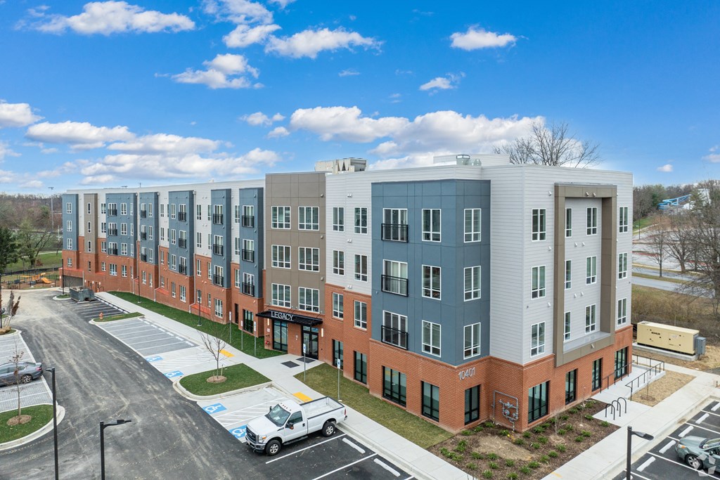 an aerial view of an apartment building on a city street