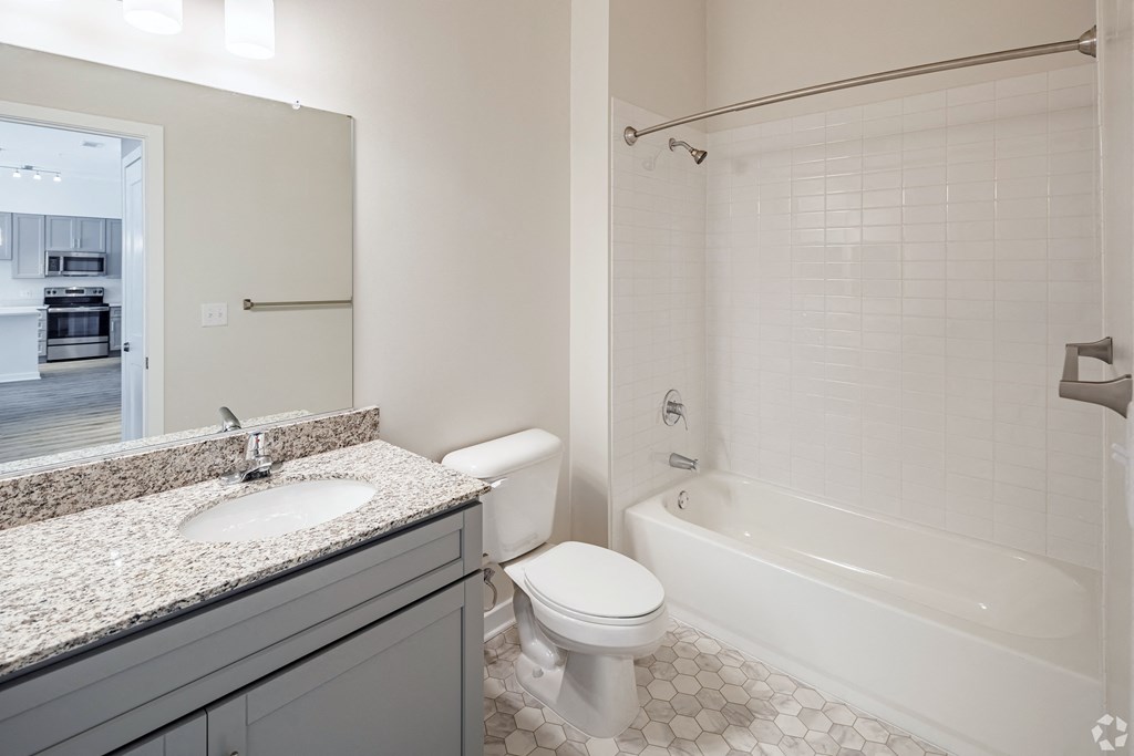 a bathroom with a sink toilet and a bath tub