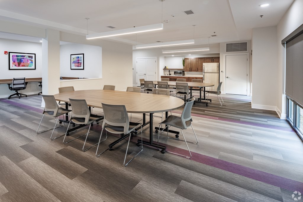 a large meeting room with a large table and chairs