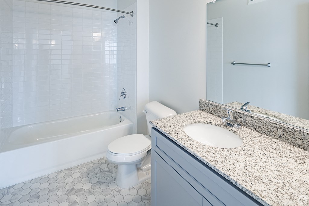 a bathroom with a toilet and a sink and a tub