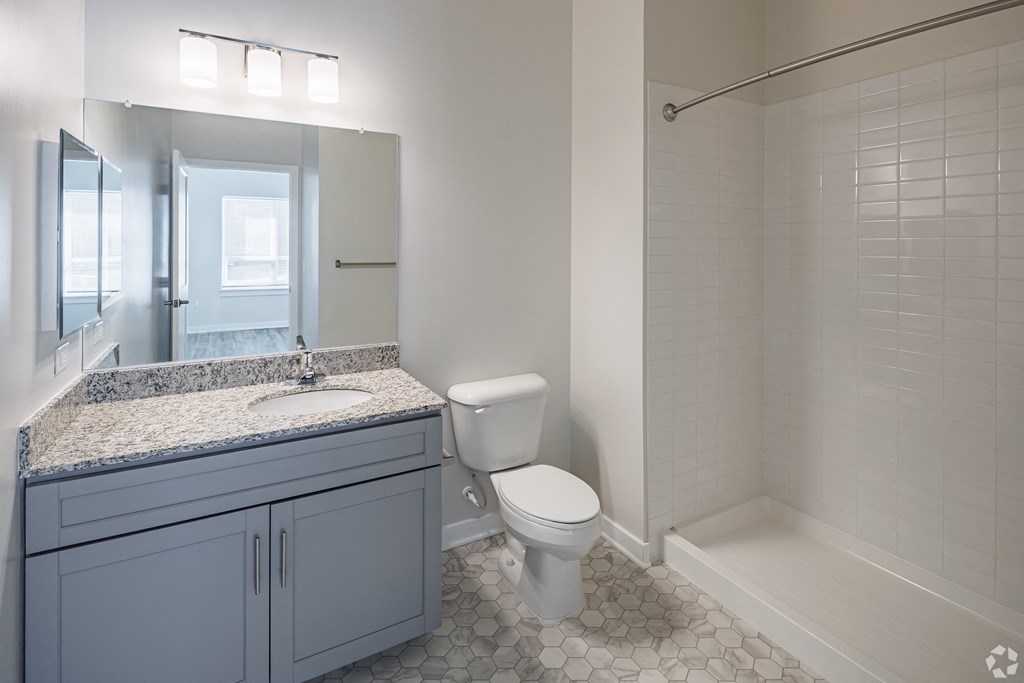 a bathroom with a toilet and a sink and a shower