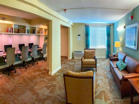 a conference room with a table and chairs and a couch