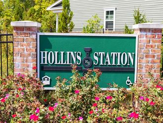 a sign for the hollings station in front of a house