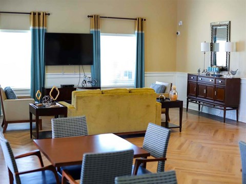 a living room with a couch and a table and chairs