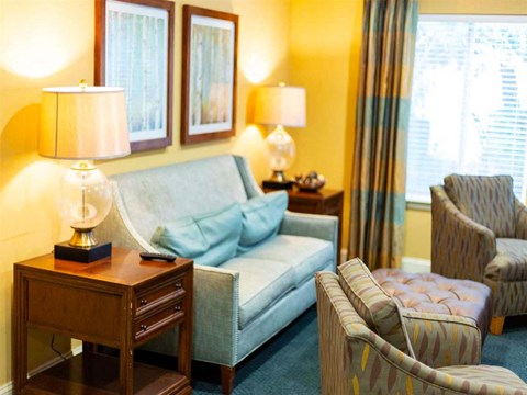 a living room with a couch and chairs and a table
