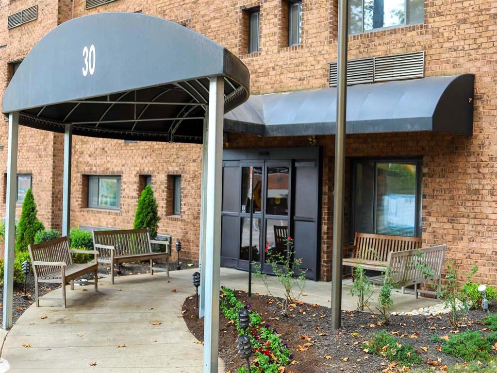 the outside of a building with benches and an awning