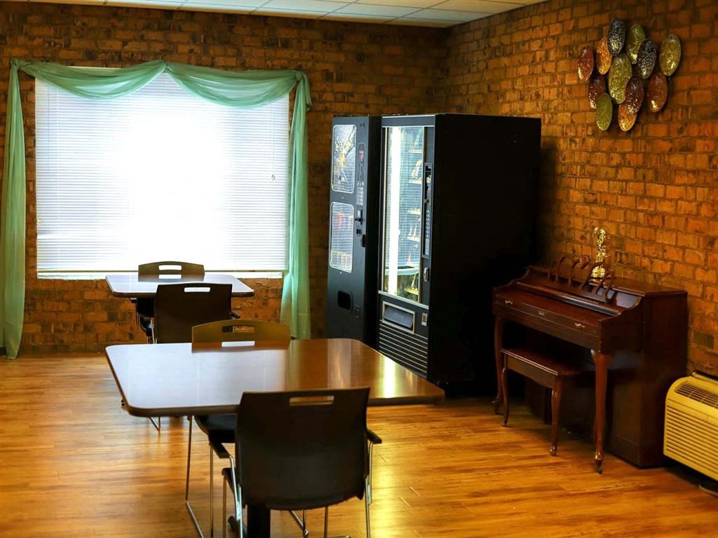 a dining room with a table and a piano