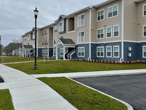a row of town houses on a street with a sidewalk