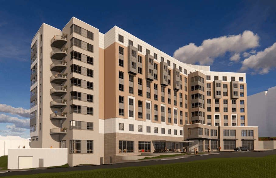 A large, modern building with a mix of beige and brown colors.