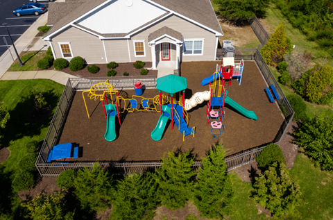 A playground with a slide, swings, and a ball pit.