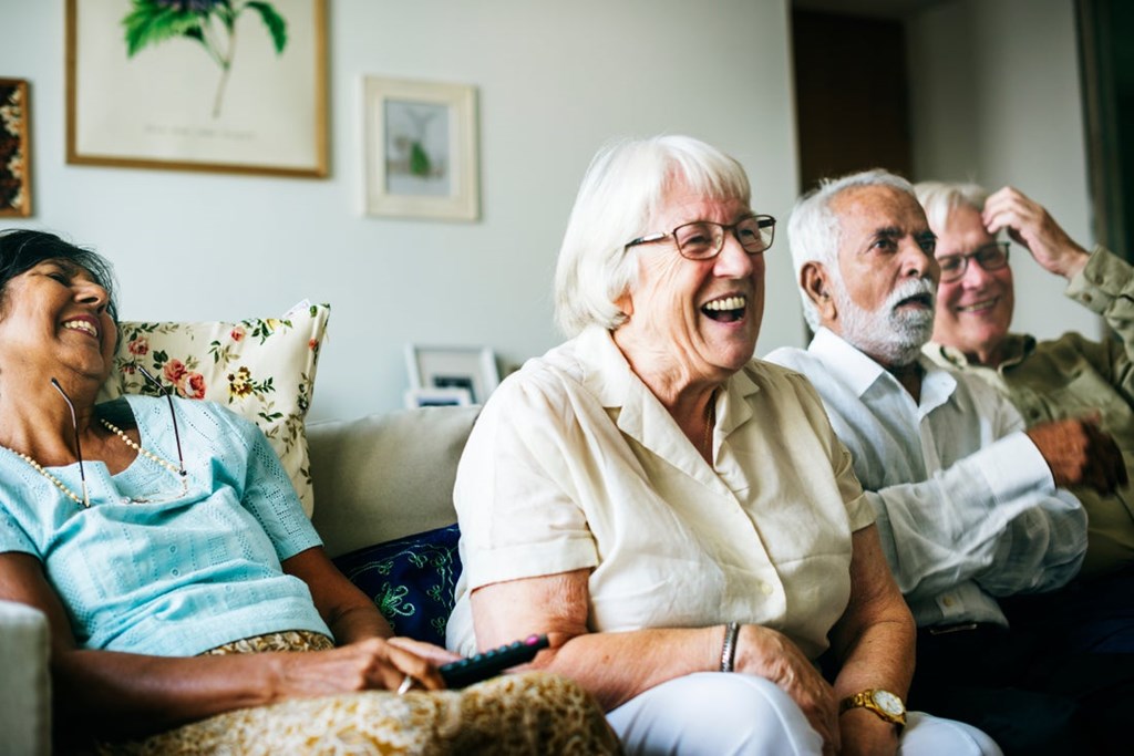 Group of older adults relaxing together at Greens at Irvington Mews II, affordable senior apartments in Baltimore.