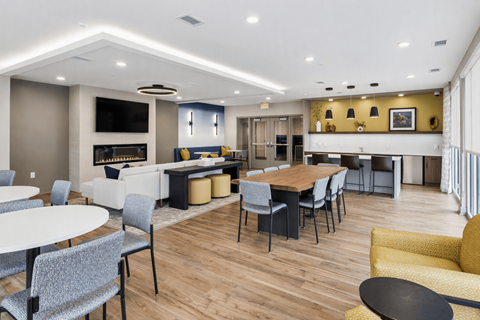 A modern dining room with a wooden table and chairs.