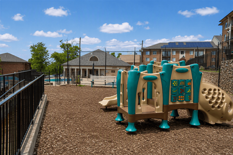 A playground with a large slide and a play structure.