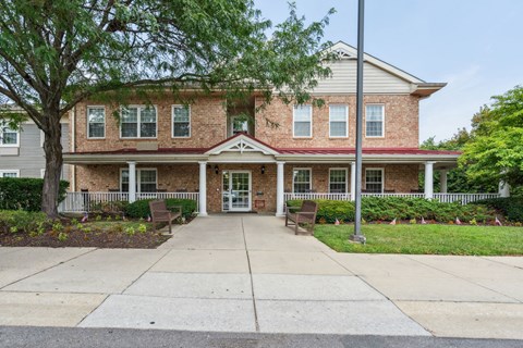 A two-story brick house with a front porch.