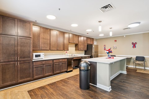 A kitchen with wooden cabinets and a white counter.