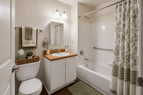 A white bathroom with a toilet, sink, and bathtub.