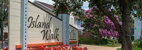 a white building with a sign on the side of a street