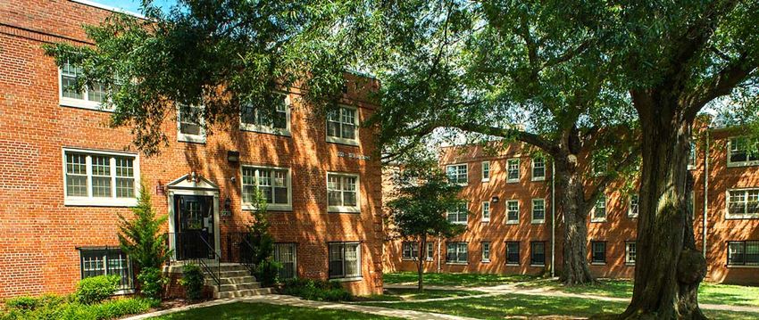 a red brick building with trees in front of it