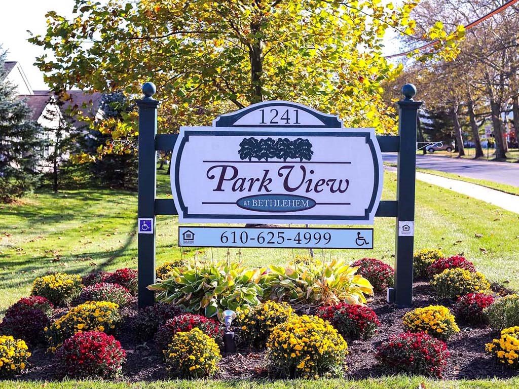 park view sign in front of a yard with flowers