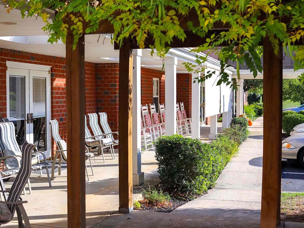 a row of chairs and tables in front of a building